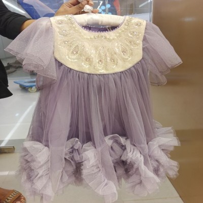 Color: Lavender / Purple with Cream/Ivory bodice Style: Princess / Tutu / Party Dress Neckline: Round neck with embellished yoke Sleeves: Short sheer ruffled tulle flutter sleeves Skirt: Multi-layered soft tulle with ruffled hem Embellishments: Heavy pear